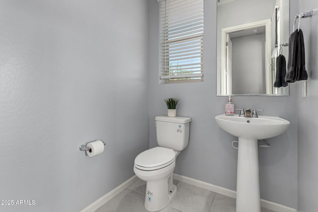 bathroom featuring toilet and baseboards