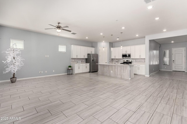 kitchen with light countertops, open floor plan, and stainless steel appliances