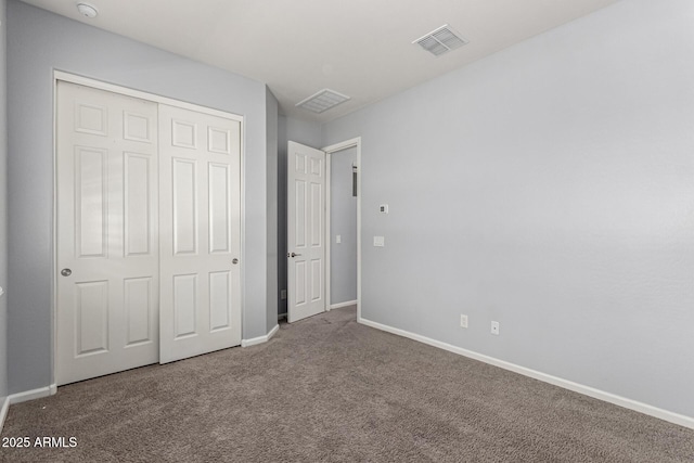 unfurnished bedroom with baseboards, carpet, a closet, and visible vents