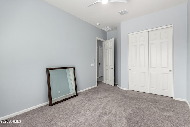 unfurnished bedroom featuring ceiling fan, carpet, baseboards, visible vents, and a closet
