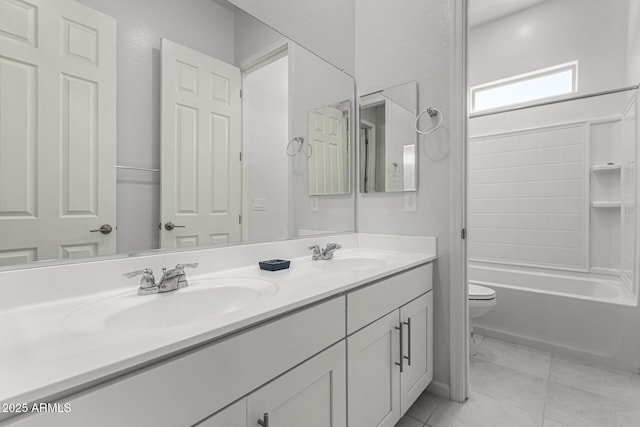 full bath with a sink, shower / bathtub combination, toilet, and double vanity