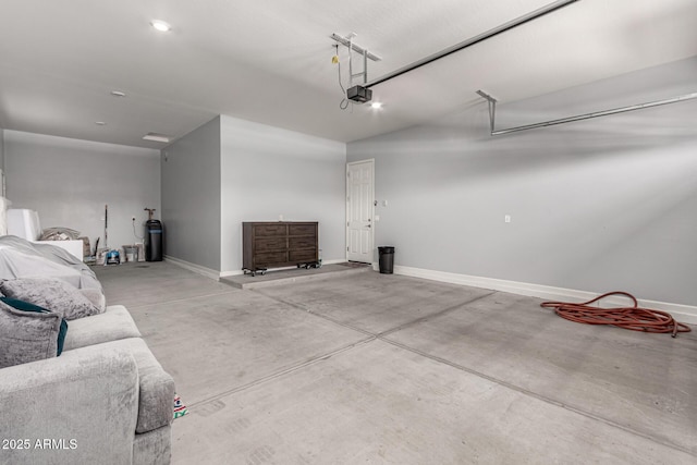 garage with baseboards and a garage door opener
