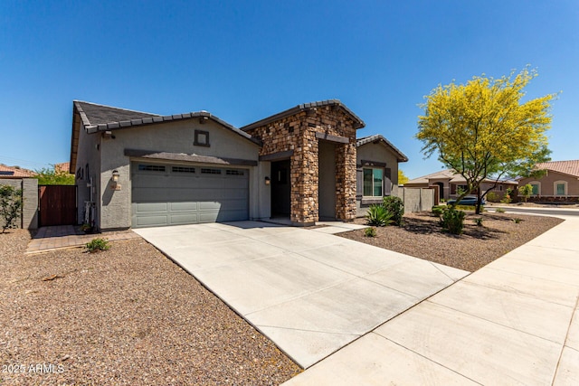 single story home featuring a gate, an attached garage, concrete driveway, and stucco siding