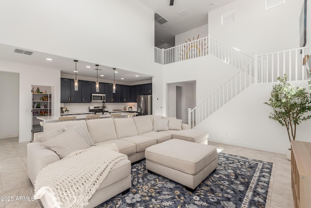 5330 W Thresher Way, Laveen, AZ 85339 - living area with a high ceiling, recessed lighting, baseboards, light tile patterned floors, and stairway