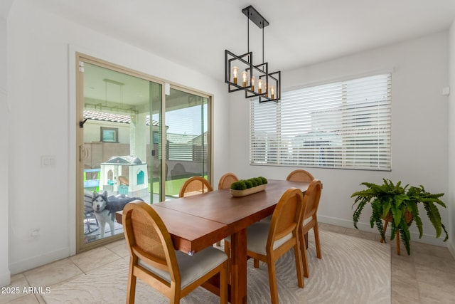 5330 W Thresher Way, Laveen, AZ 85339 - dining space with a chandelier, baseboards, and light tile patterned floors
