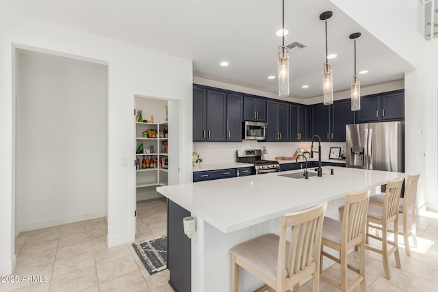 5330 W Thresher Way, Laveen, AZ 85339 - kitchen with stainless steel appliances, a sink, a kitchen bar, light countertops, and baseboards