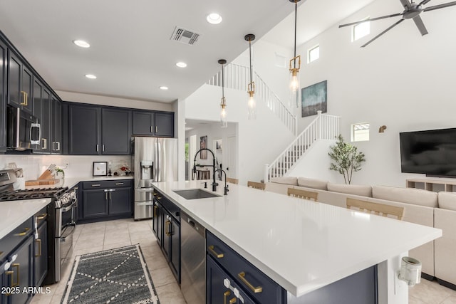 5330 W Thresher Way, Laveen, AZ 85339 - kitchen featuring appliances with stainless steel finishes, a sink, open floor plan, light countertops, and recessed lighting
