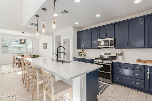 5330 W Thresher Way, Laveen, AZ 85339 - kitchen featuring stainless steel appliances, a sink, light tile patterned floors, a kitchen breakfast bar, and light countertops