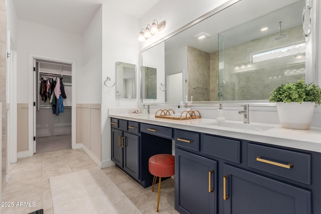5330 W Thresher Way, Laveen, AZ 85339 - full bath with double vanity, tiled shower, a walk in closet, a wainscoted wall, and tile patterned flooring