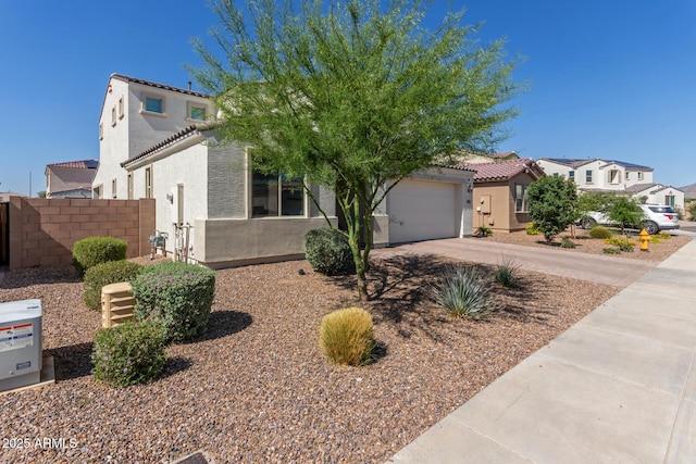 5330 W Thresher Way, Laveen, AZ 85339 - mediterranean / spanish-style home featuring stucco siding, a tiled roof, concrete driveway, a residential view, and an attached garage