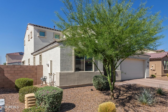 5330 W Thresher Way, Laveen, AZ 85339 - mediterranean / spanish home with stucco siding, concrete driveway, a tile roof, and an attached garage