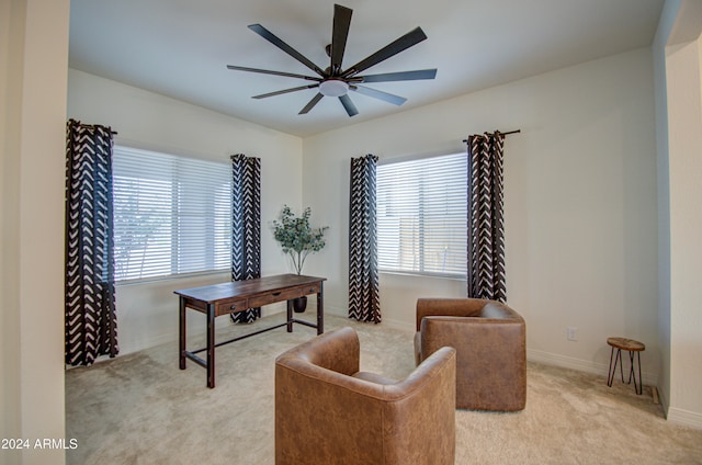 office space with a wealth of natural light, ceiling fan, and light carpet