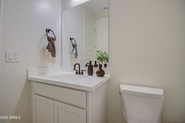 bathroom featuring toilet and vanity