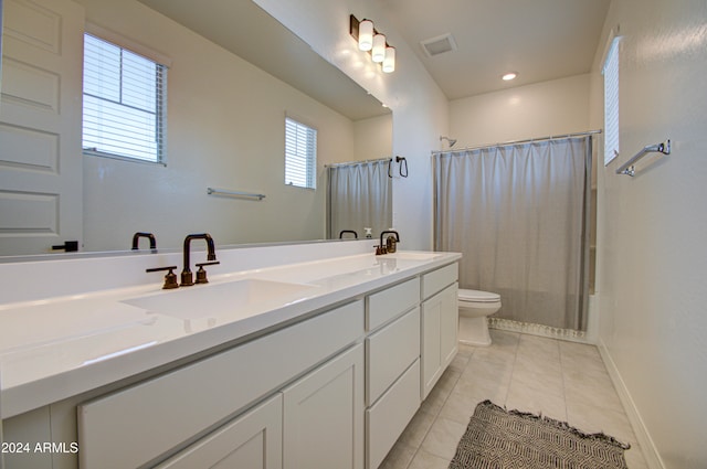 bathroom featuring vanity, curtained shower, tile patterned flooring, and toilet