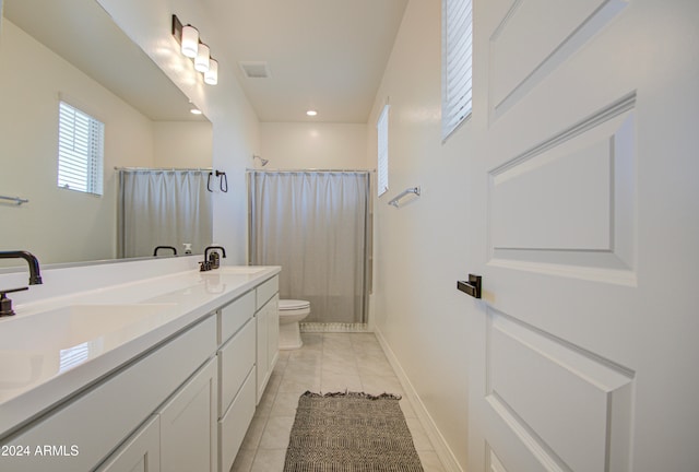 bathroom with vanity, tile patterned floors, toilet, and a shower with curtain