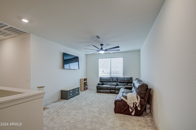 carpeted living room with ceiling fan