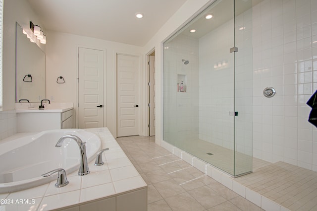 bathroom featuring tile patterned flooring, vanity, and independent shower and bath