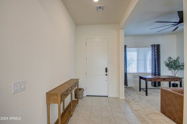 carpeted foyer featuring ceiling fan