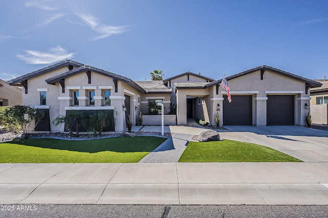 view of front of house featuring a front lawn, a garage, driveway, and stucco siding