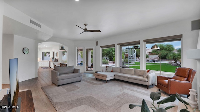 living room featuring light wood-type flooring and ceiling fan