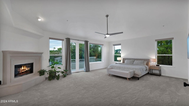 bedroom featuring lofted ceiling, light colored carpet, access to exterior, and ceiling fan