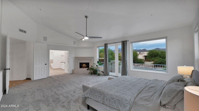 bedroom featuring access to exterior, high vaulted ceiling, light colored carpet, ceiling fan, and connected bathroom