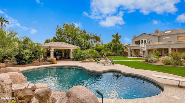 view of swimming pool with a patio and a yard