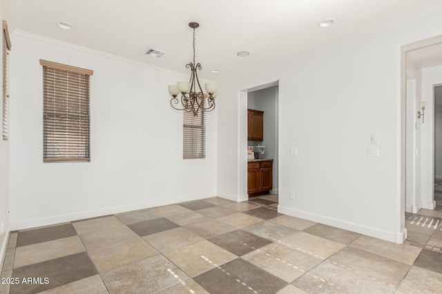 unfurnished dining area featuring ornamental molding and a chandelier