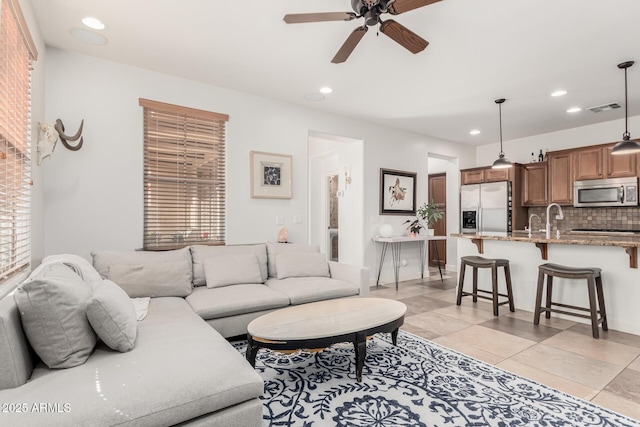 living room featuring ceiling fan and light tile patterned flooring