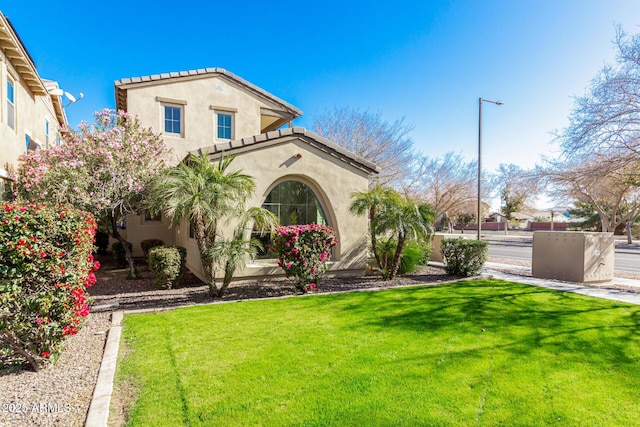 mediterranean / spanish home featuring a front yard