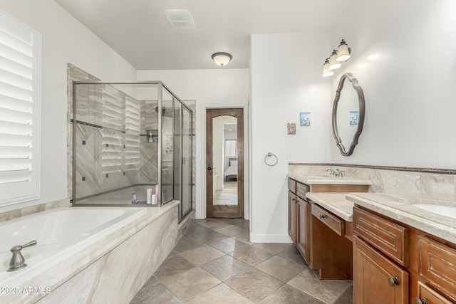 bathroom with tile patterned floors, separate shower and tub, and vanity