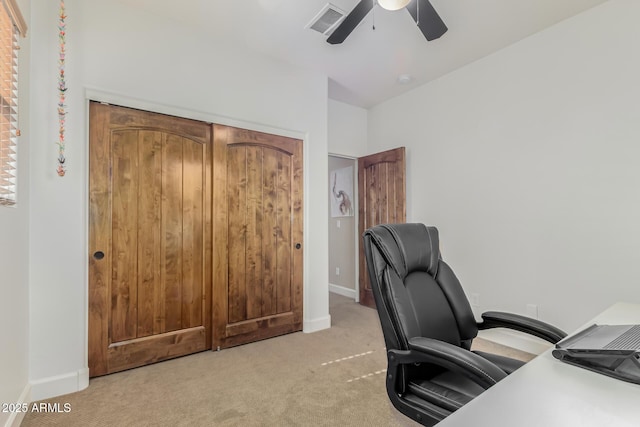 carpeted home office with ceiling fan