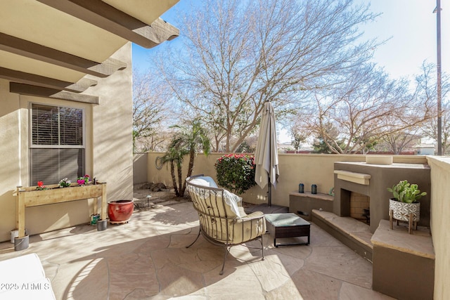 view of patio featuring an outdoor fireplace