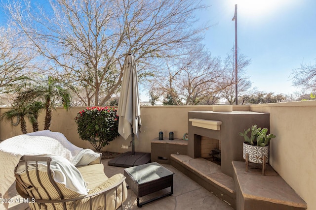 view of patio / terrace featuring an outdoor fireplace