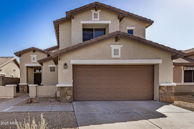 view of front of house featuring a tiled roof, stone siding, driveway, and stucco siding