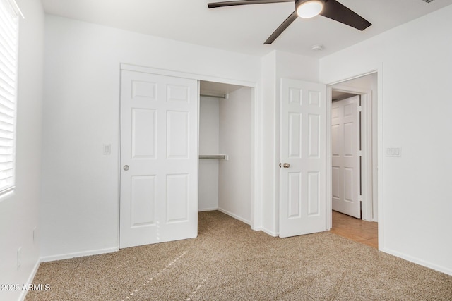 unfurnished bedroom featuring a closet, baseboards, and carpet