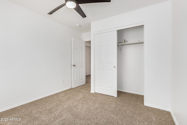 unfurnished bedroom with carpet flooring, a ceiling fan, baseboards, and a closet