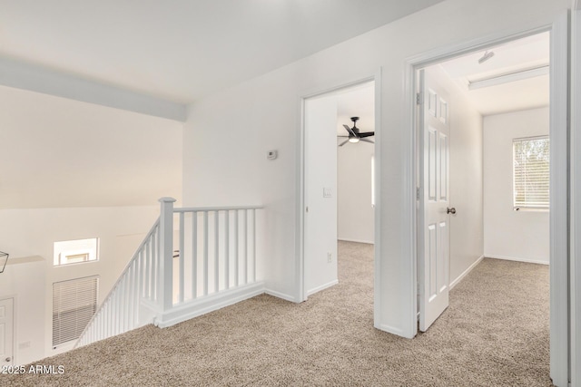 carpeted empty room with baseboards