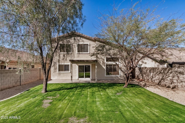 back of property with a patio, a yard, a fenced backyard, stucco siding, and a tile roof