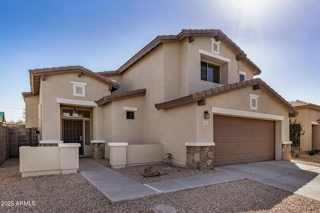 view of front of home featuring concrete driveway, fence, stone siding, and stucco siding