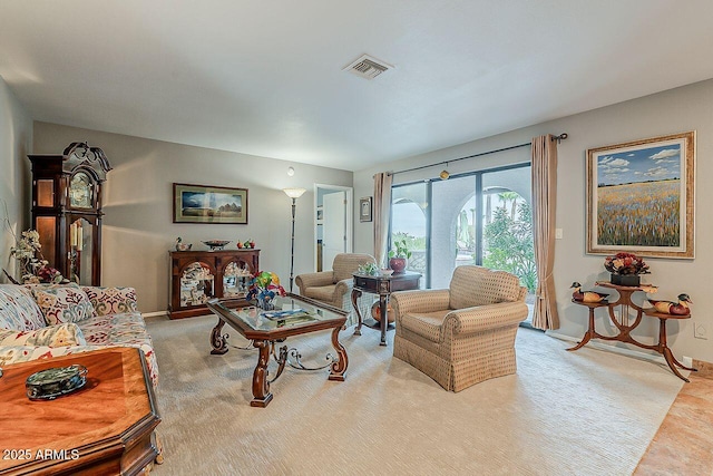 carpeted living area with visible vents and baseboards