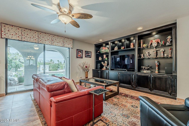 living room featuring light tile patterned floors and a ceiling fan