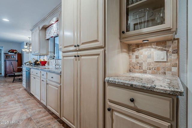 kitchen with a sink, decorative backsplash, light stone countertops, dishwasher, and glass insert cabinets