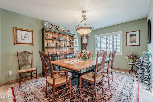 dining space featuring baseboards