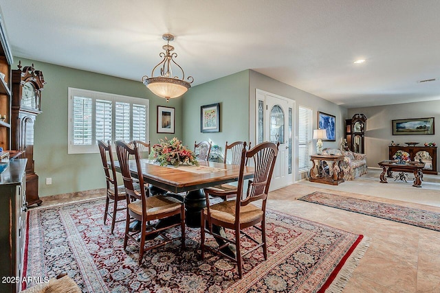 dining room with baseboards and visible vents