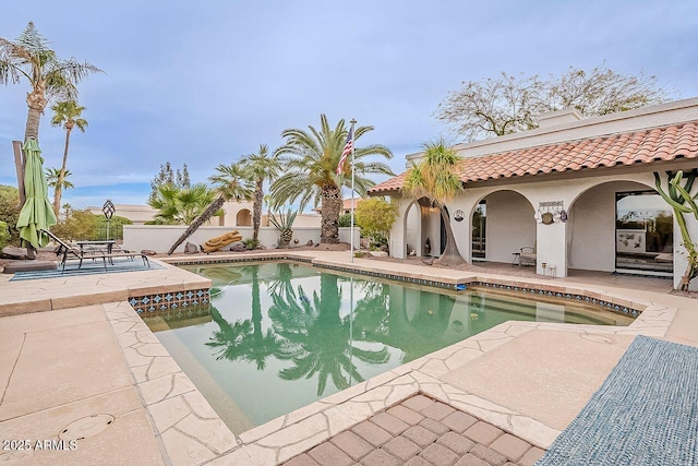 view of swimming pool with a patio area, fence, and a fenced in pool