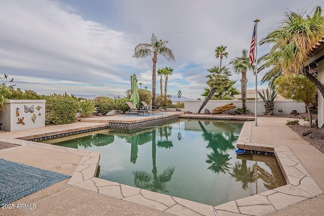 view of swimming pool with a fenced backyard, a fenced in pool, and a patio