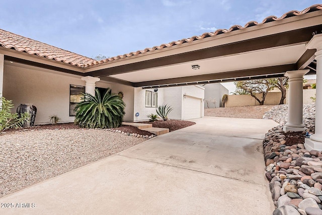 view of front facade featuring a garage, concrete driveway, and stucco siding