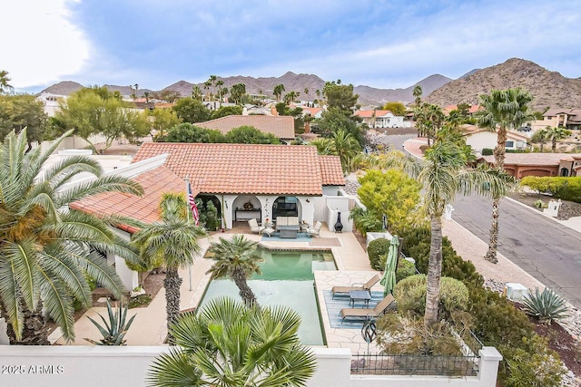 exterior space featuring a patio area, a fenced backyard, and a mountain view