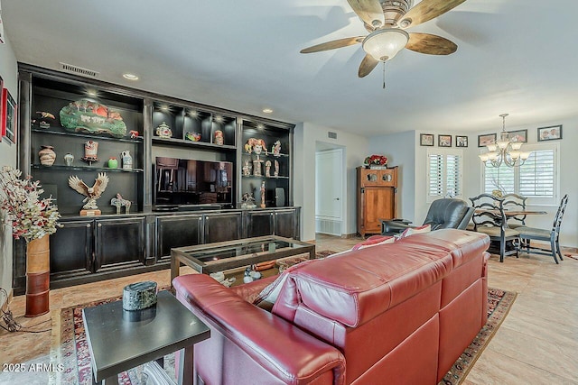 living room featuring visible vents and ceiling fan with notable chandelier